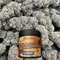Biscotti container with flower on a textured background