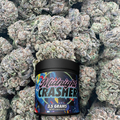 Jar of 'Midnight Crasher' surrounded by buds