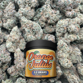 Jar of 'Orange Julius' on a bed of green buds