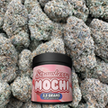 Container of strawberry mochi on a bud background